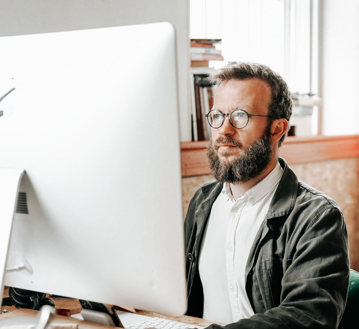 Fraser Malyk working at his desk in Leeds